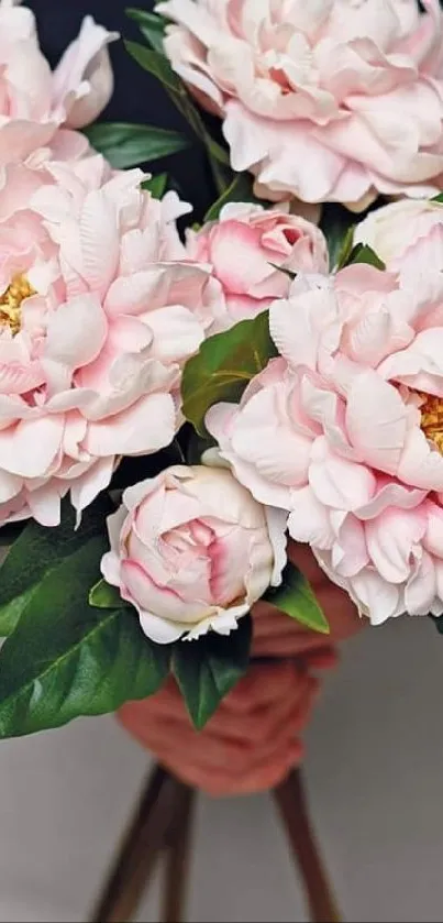 Elegant pink flower bouquet with green leaves.