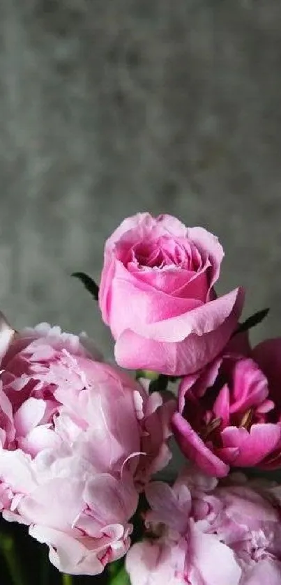 Elegant pink floral wallpaper with roses against a textured background.