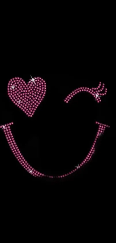 Pink gemstone smiley face on black background wallpaper.