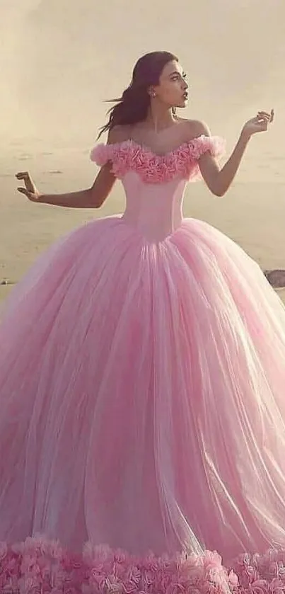 Woman in elegant pink ball gown on a tranquil beach.