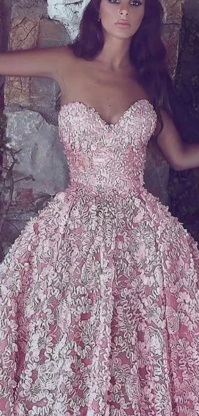 Woman in pink gown with intricate lace on mobile wallpaper.