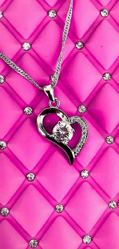 Pink quilted background with heart necklace.