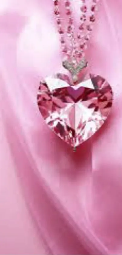 Pink heart pendant on silky pink background wallpaper.