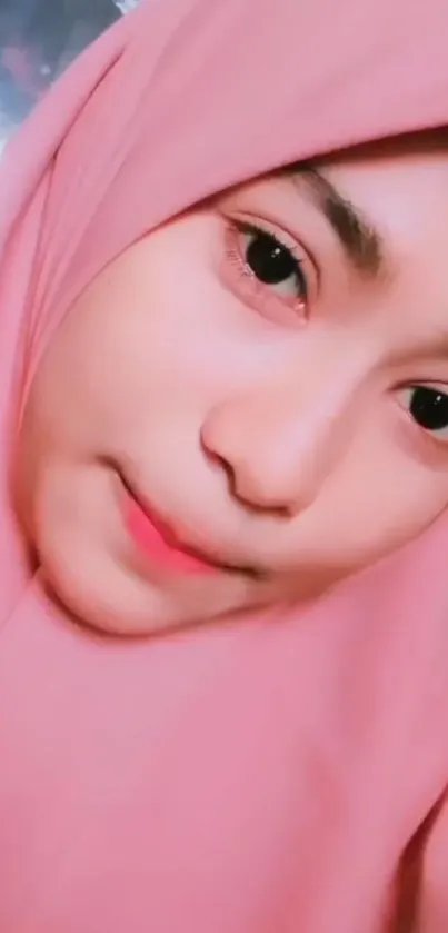 Portrait of a woman in a pink hijab, close-up shot.