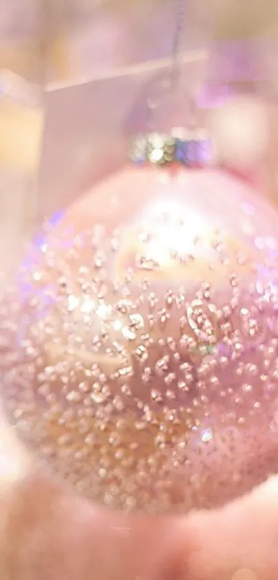 Sparkling pink ornament with a festive glow.