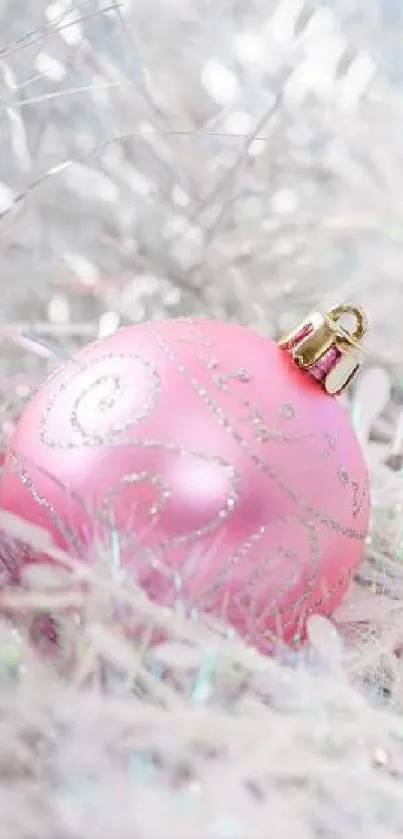 Elegant pink Christmas ornament on a sparkling background.