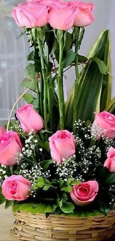 A beautiful bouquet of pink roses in a basket with green leaves.