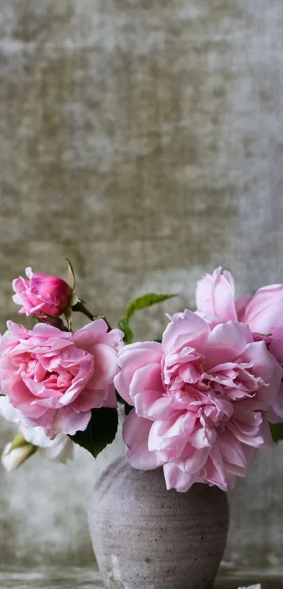 Delicate pink roses in a vase on textured background wallpaper.