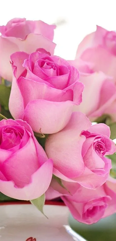 Vibrant pink roses in a white vase, perfect for mobile wallpaper.