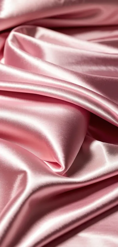 Luxurious pink silk fabric with elegant folds.