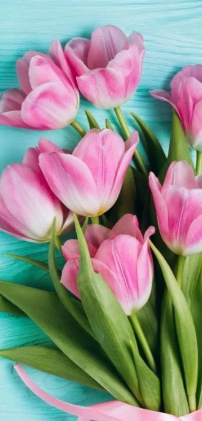 Elegant bouquet of pink tulips on aqua background.