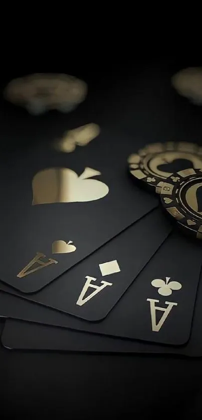 Black and gold poker cards and chips on a dark background