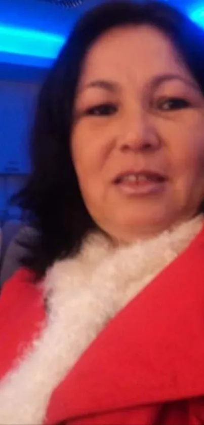 Portrait of woman in a red coat smiling.