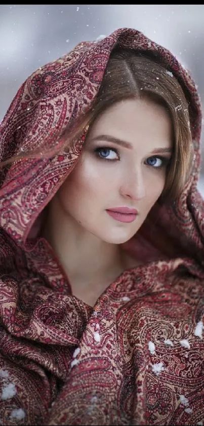 Portrait of woman with maroon shawl in snowy winter setting.