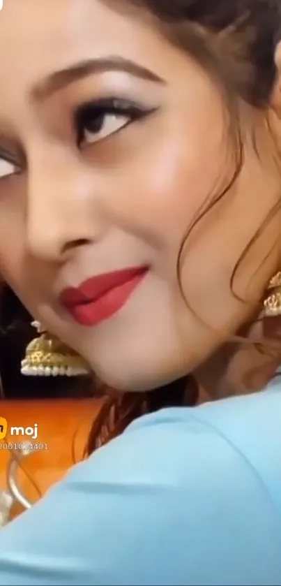 Elegant woman with red lips and golden earrings.