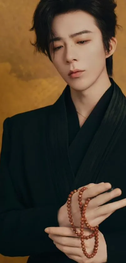 A stylish person with prayer beads against a gold background.