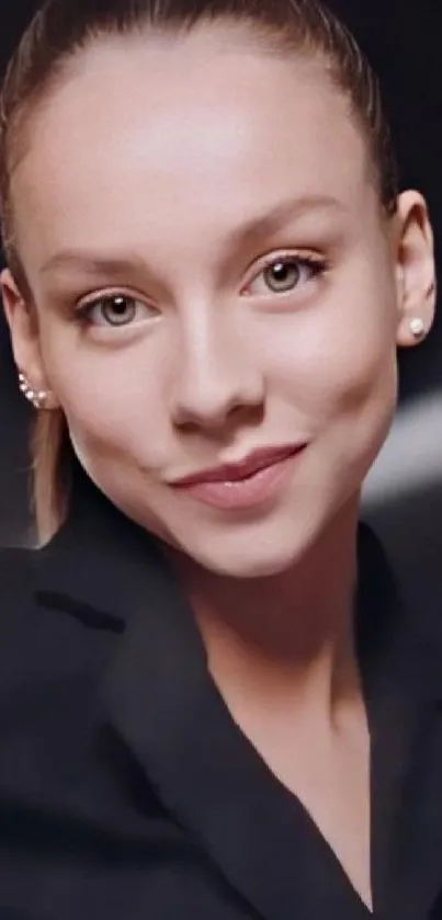 Elegant portrait of a young woman with a calm expression on a black background.