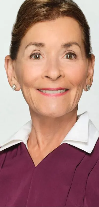 Elegant portrait of a woman in a burgundy robe on a light background.