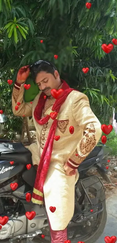 Man posing elegantly on motorcycle with red hearts and greenery.