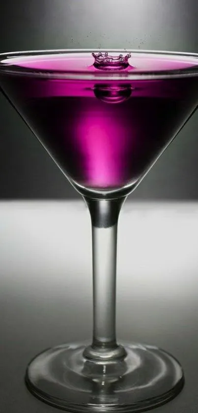 Purple cocktail in a martini glass with elegant lighting.