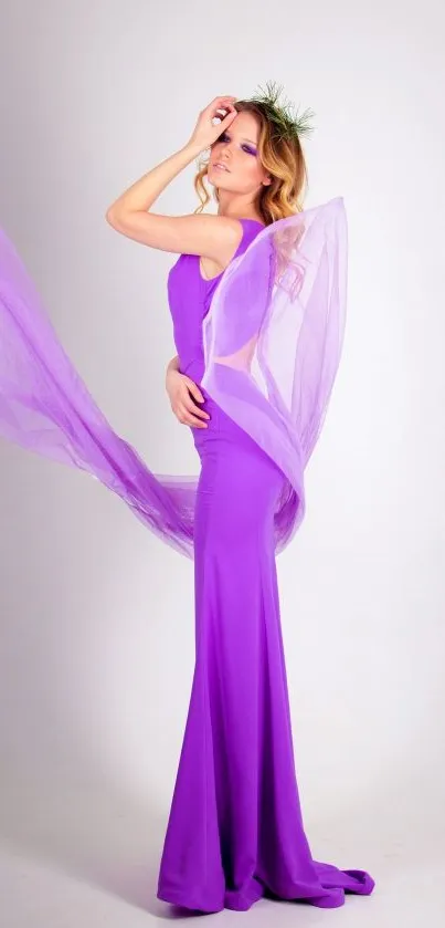 Woman in flowing purple dress with elegant styling.