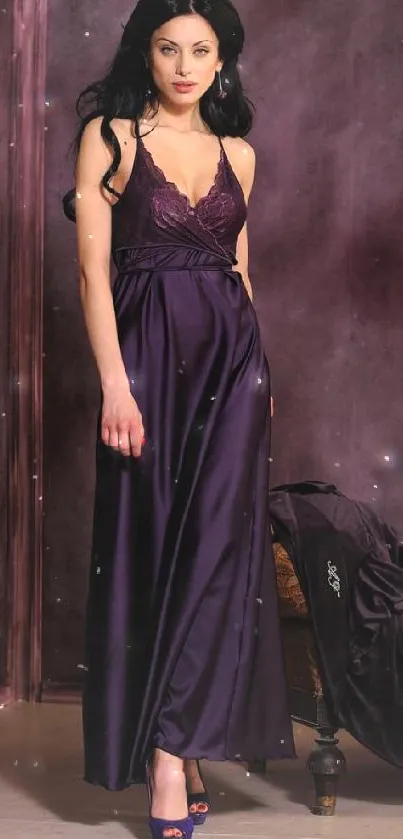 Model in purple evening gown against purple backdrop.