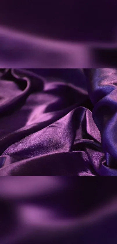 Purple silk fabric with flowing waves texture.