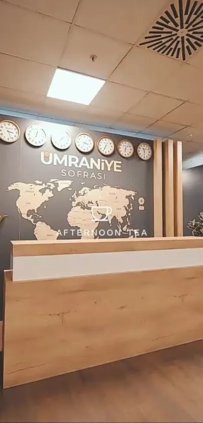 Modern reception desk with world map and clocks on gray wall.