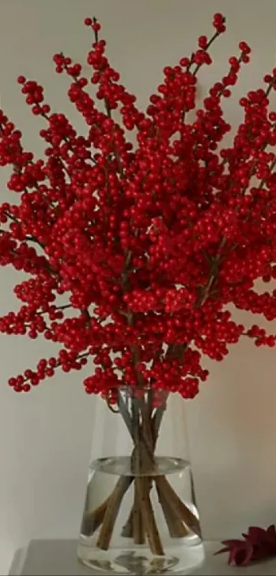 Elegant vase with red berries and candle on a shelf.