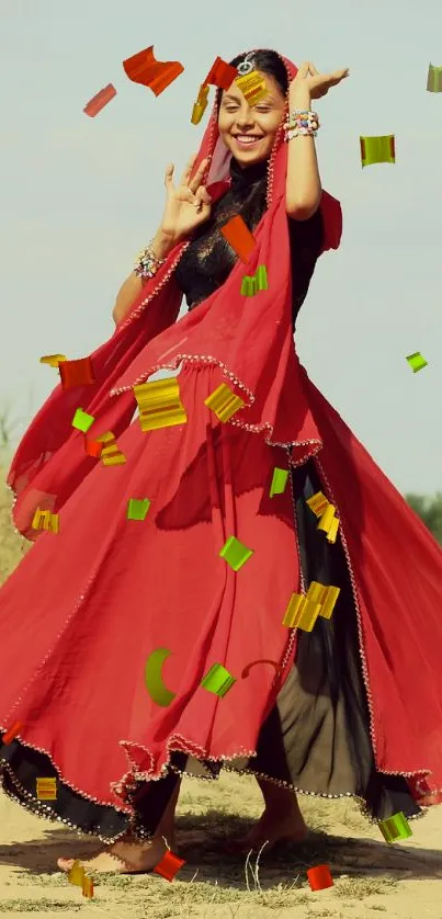 Woman dancing in a vibrant red dress on a dusty path under a blue sky.