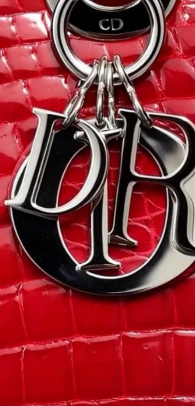 Red designer leather with metallic charm.