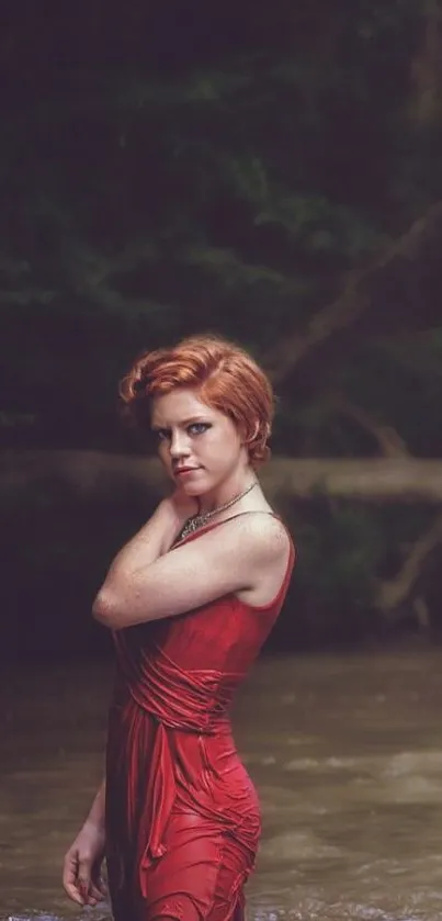 Woman in a red dress standing in natural surroundings.