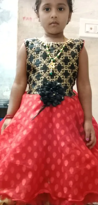 Young girl in a black and red dress with intricate details.