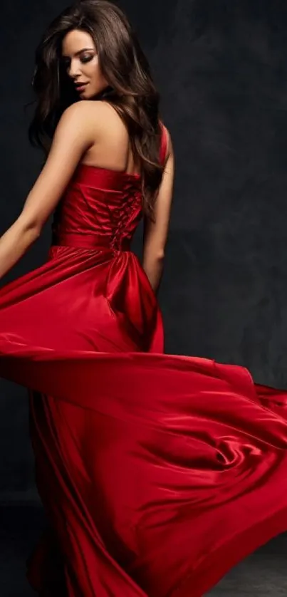 Woman in a striking red dress against a dark backdrop.