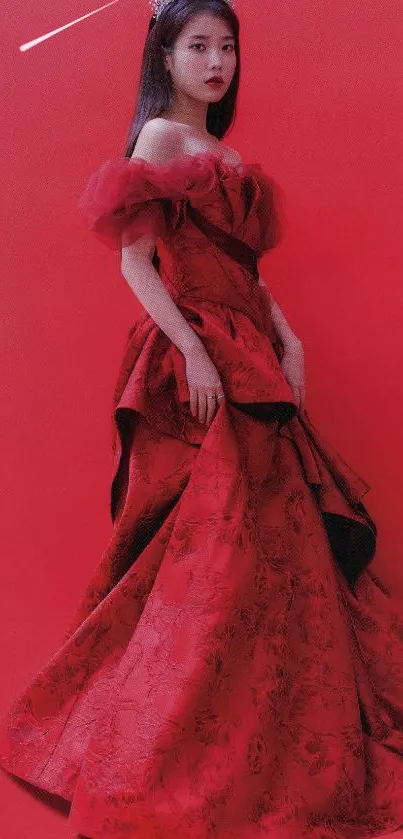 Elegant woman in a red dress with a crown on a red background.