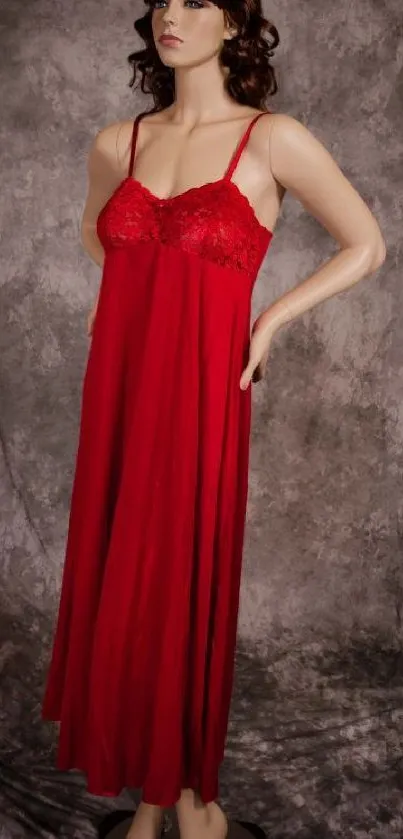 Mannequin wearing an elegant red dress against a textured background.