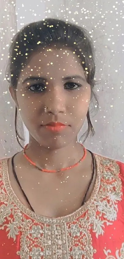 Woman in red ethnic attire with intricate embroidery.