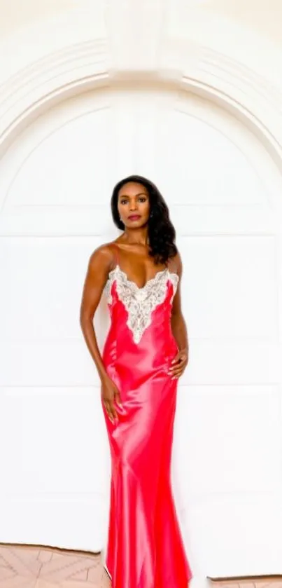 Woman in elegant red evening dress in front of a white arch doorway.