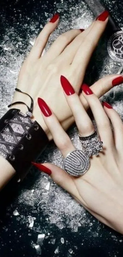 Elegant hands with red nails, stylish jewelry on black background.