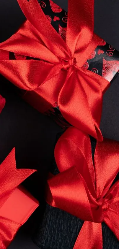 Elegant red ribbon gift boxes on a dark background.