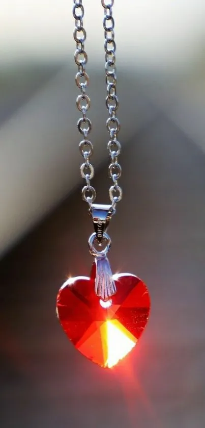 Red heart pendant on chain catches light beautifully.