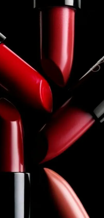 Elegant red lipsticks on a black background for mobile wallpaper.