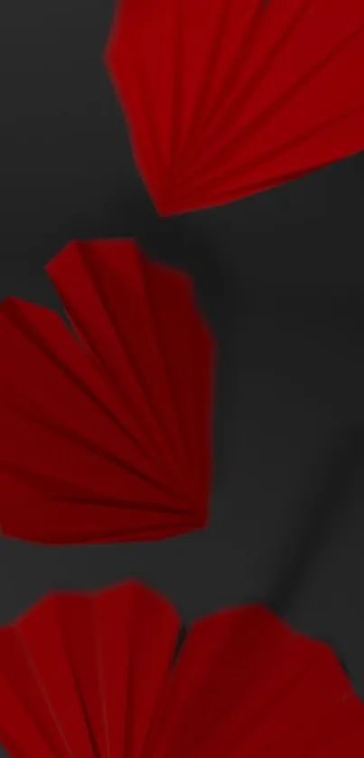 Red origami hearts on a black background, creating an elegant mobile wallpaper.