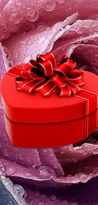 Heart-shaped red gift box on a dewy pink rose background.