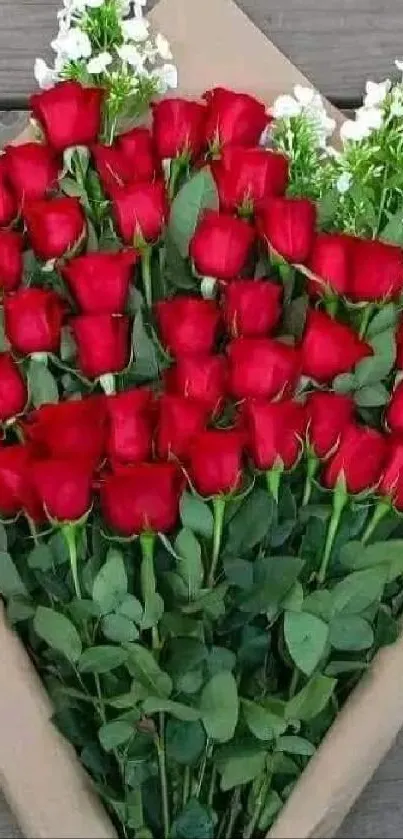 Mobile wallpaper of elegant red roses bouquet against a wooden background.