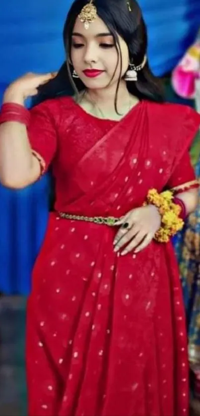 Woman in an elegant red saree with jewelry