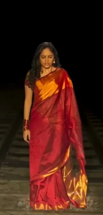 Woman in red saree on railway track, dramatic scene.