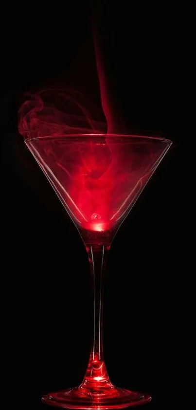 Elegant red smoke in martini glass on a black background.