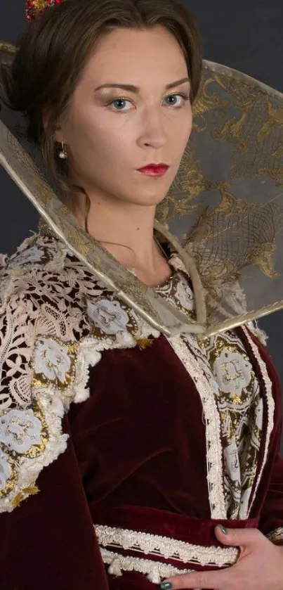 Portrait of person in regal attire with maroon and gold embroidery.