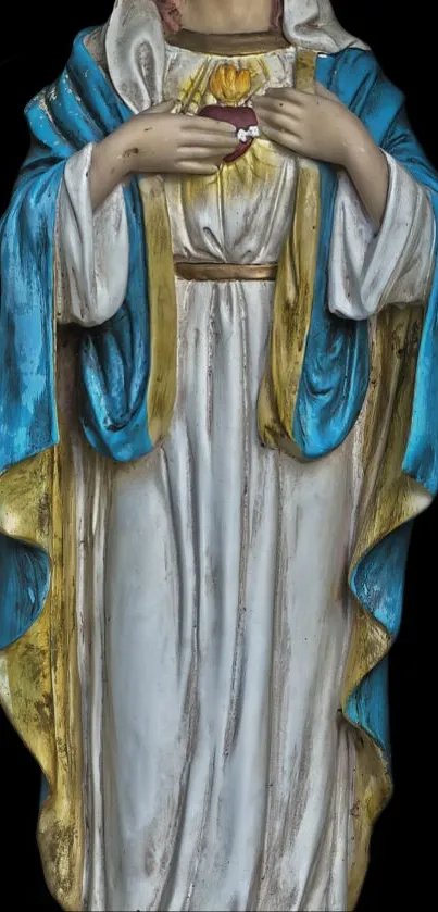 Elegant religious statue with blue and gold robes on black background.